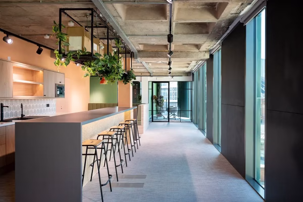 Windmill Green project seating area with large table and stools