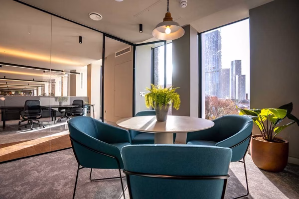 Office interior with a round table and chairs by window